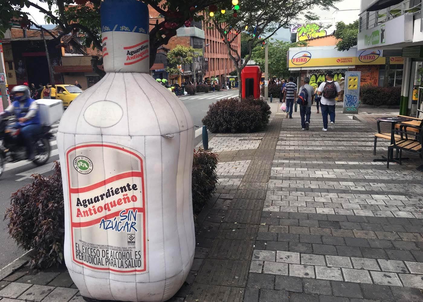 Inflatable bottle of aguardiente on Medellin sidewalk