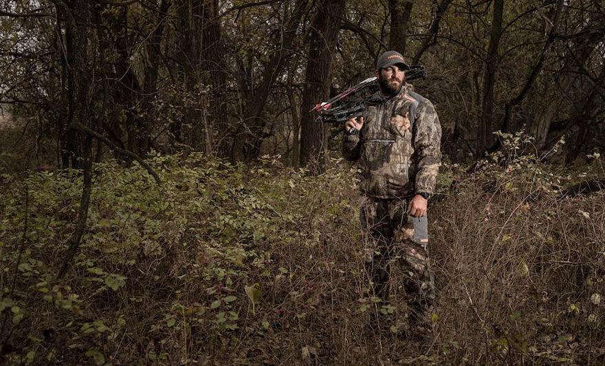 man in camouflage holding a shotgun