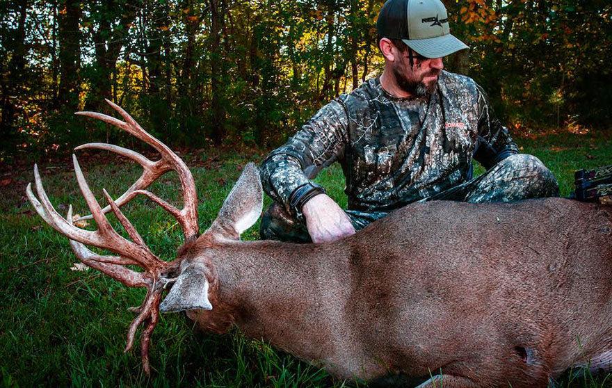 hunter holding a dead buck