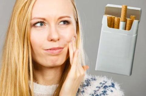 a pack of cigarettes next to a woman
