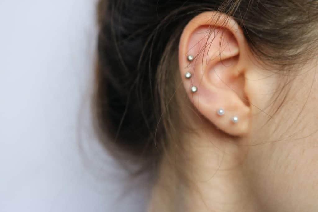 Different ear piercings on a woman's ear.