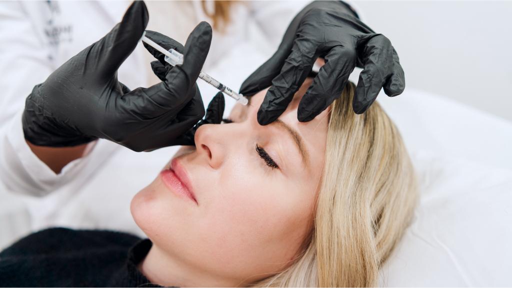 a patient getting botox injected near her eye