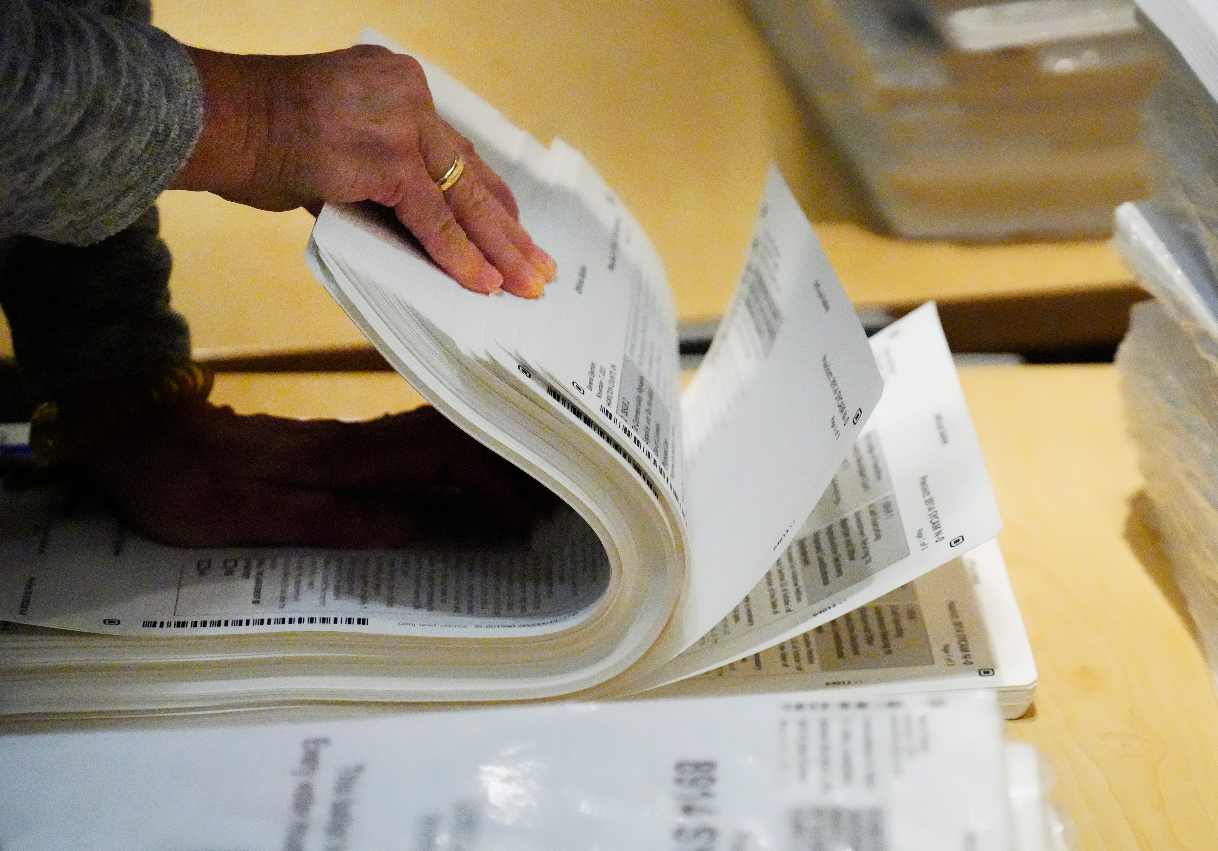 A poll worker, looks over ballots that ready for voters at Deer Park Junior and Senior High School on Election Day, Tuesday, Nov. 7, 2023. A heavy voter turnout is expected with Issue 1 to be decided, as well as Issue 22 in the city of Cincinnati.