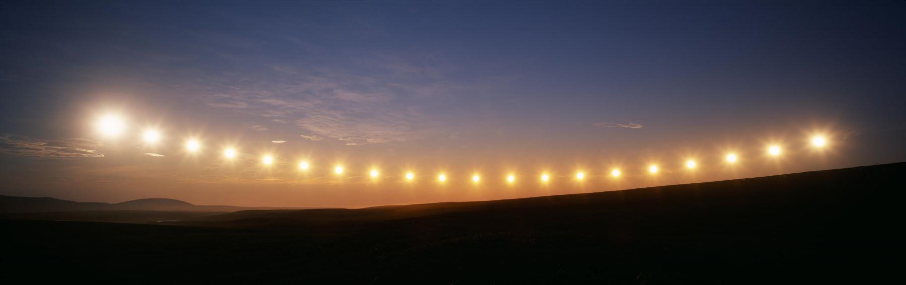 Multiple exposure image of midnight sun above the Arctic Circle, Alaska