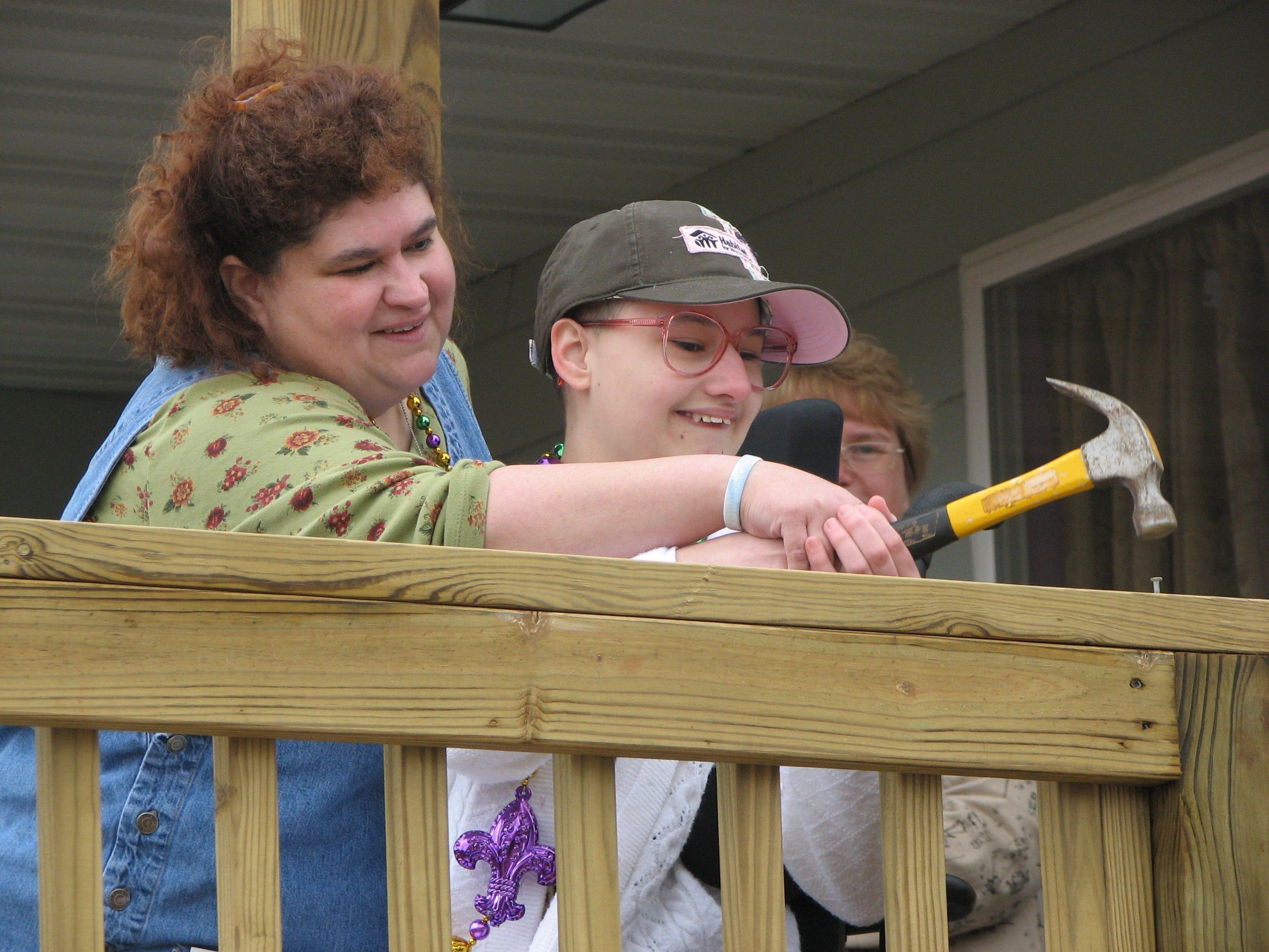 Gypsy Rose Blanchard raises her hammer during the dedication of her family