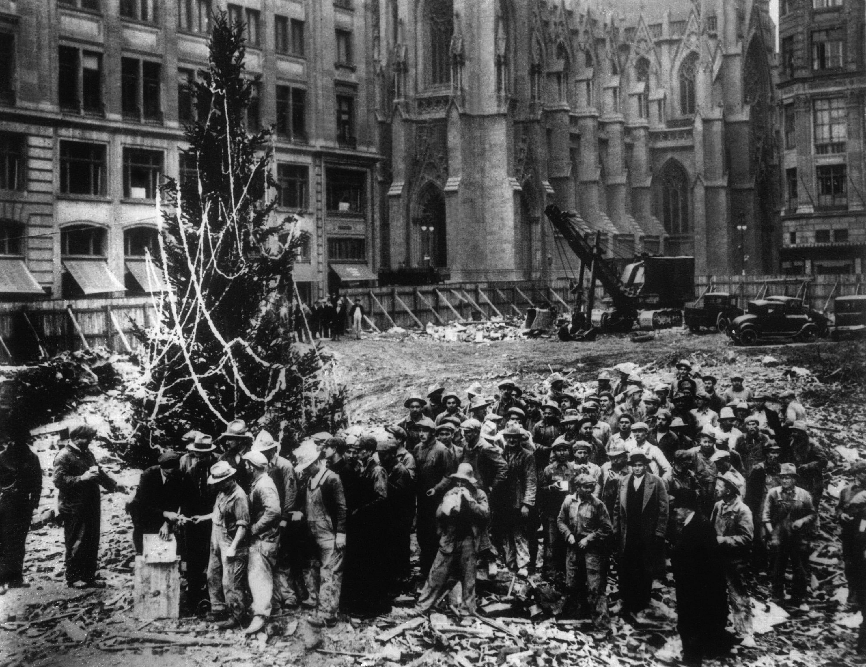 Construction workers line up for pay beside the first Rockefeller Center Christmas tree in New York in this 1931 file photo. The Christmas tree went on to become an annual tradition and a New York landmark. St. Patrick