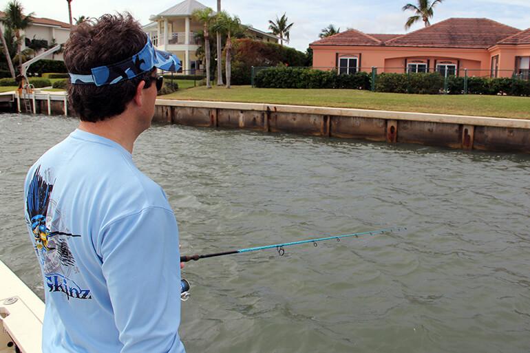 fisherman with bent rod on boat