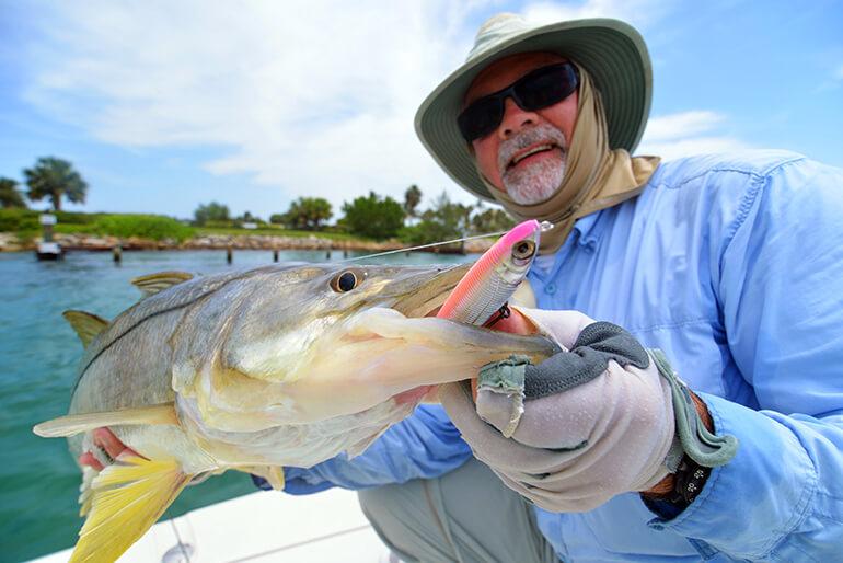 close up of jack crevalle with circle hook in corner of mouth