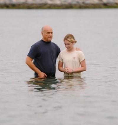 Greg Laurie, pastor and founder of Harvest Crusade and Harvest America, baptizing his granddaughter Stella at Pirate