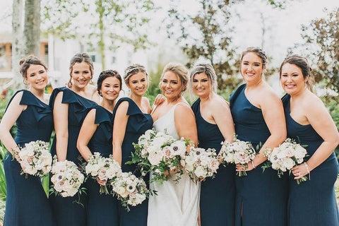 Bridesmaids in blue dresses with bride in white dress
