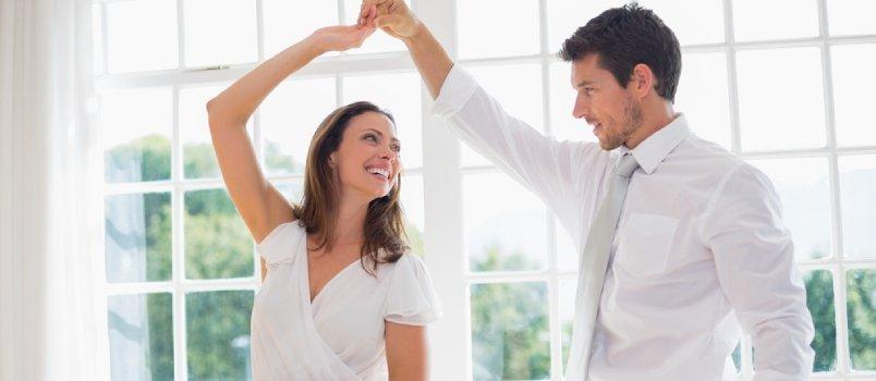 couple wearing white, dancing together