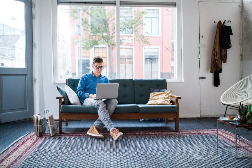 Man using a laptop on a couch