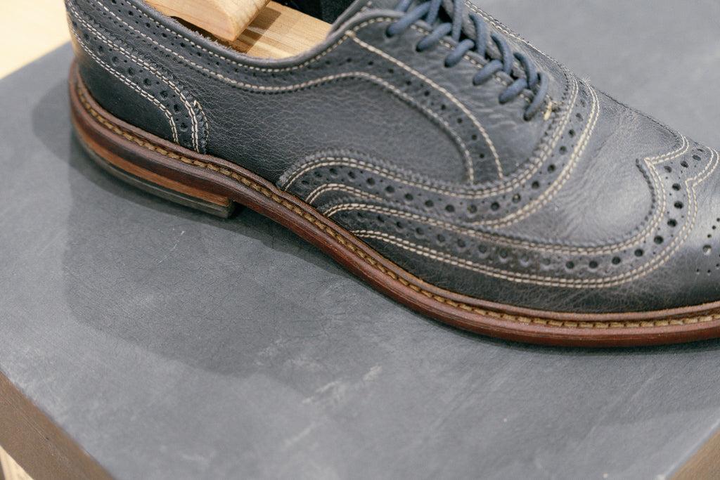 Allen Edmonds Neumonk wingtip oxford being shown in navy blue CXL leather with some contrast stithcing