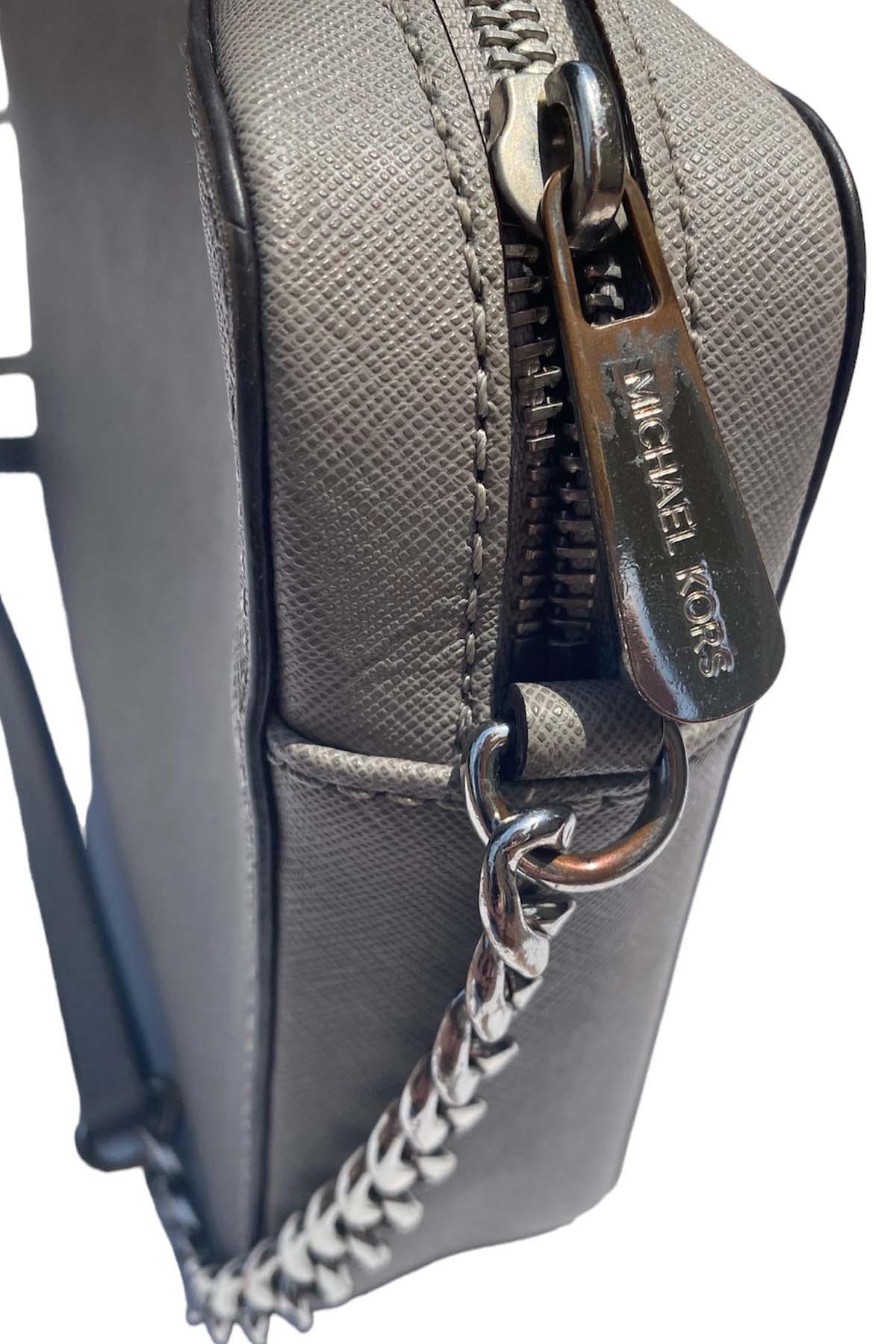close up of a michael kors purse zipper.