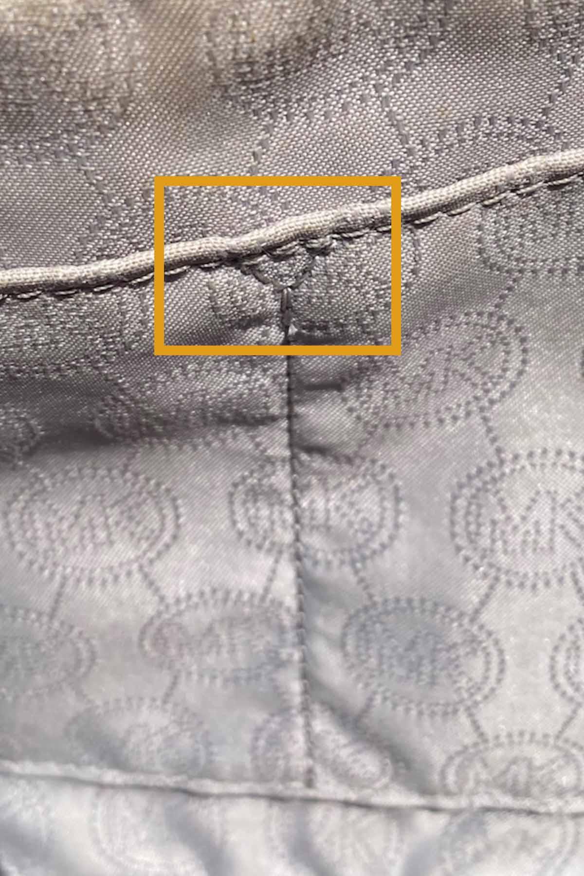 close up of the interior of a michael kors purse.