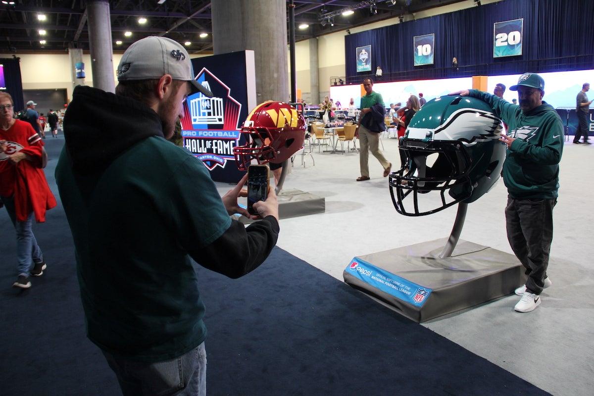 People pose with Eagles gear.