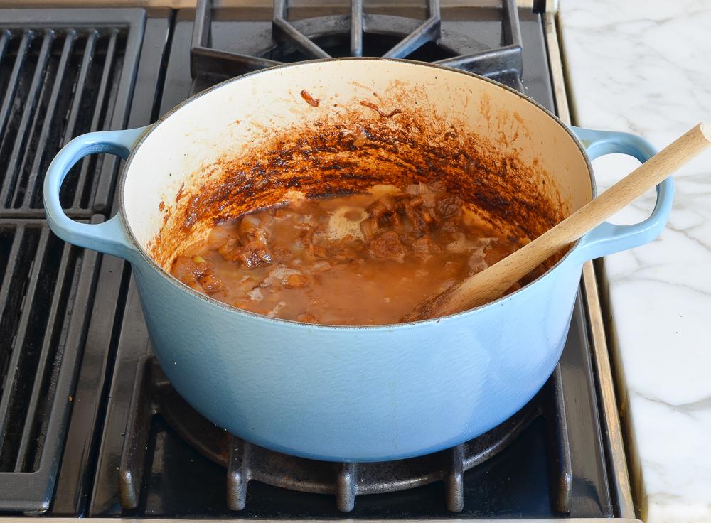 adding wine to Dutch oven