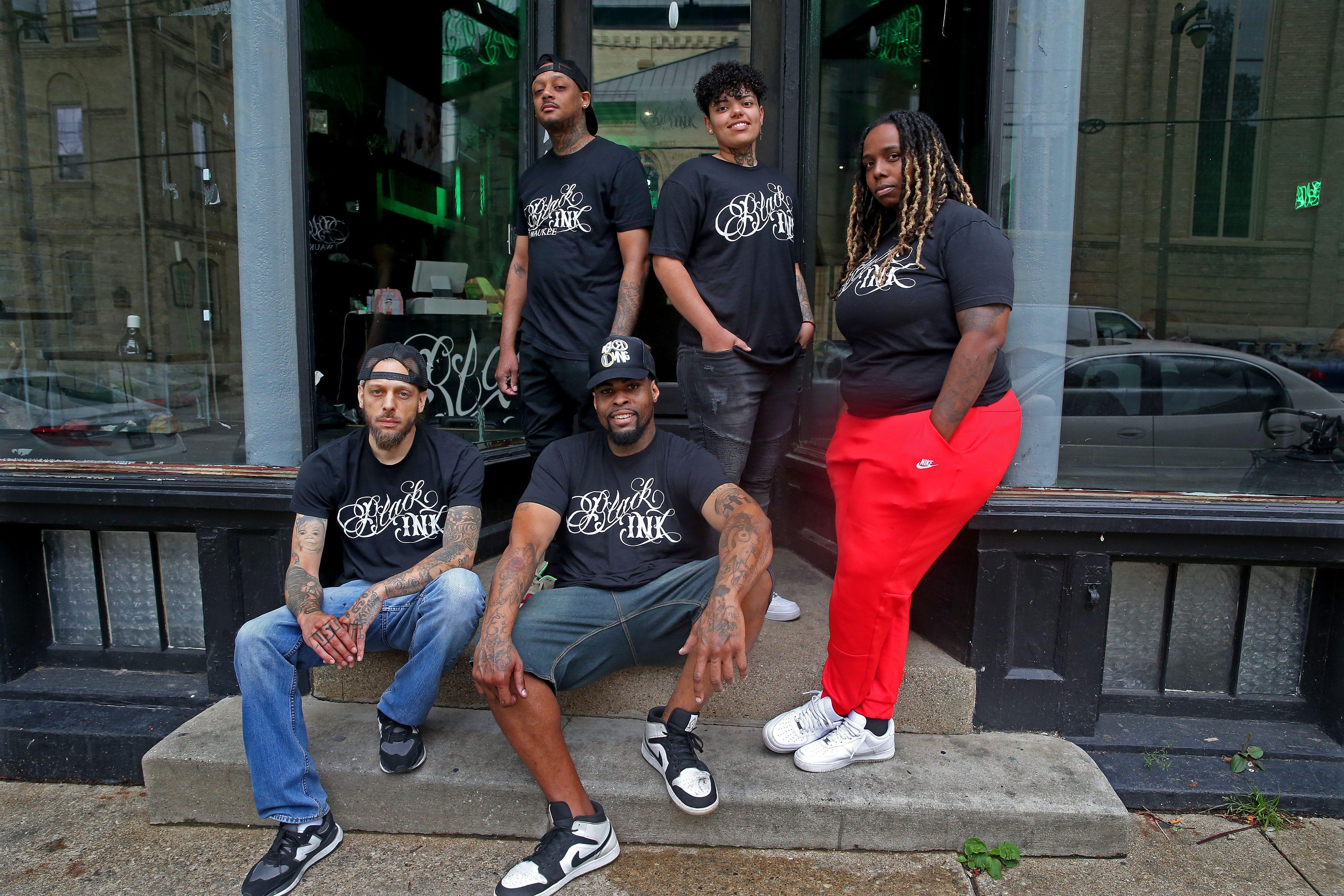 The staff of Black Ink from left seated, Kustom, Eddie Mac, standing from left, Art Lewis, Jace, Tiara McGee on E. Brady Street in Milwaukee. "Black Ink" tattoo shops became famous from the VH1 program "Black Ink crew.