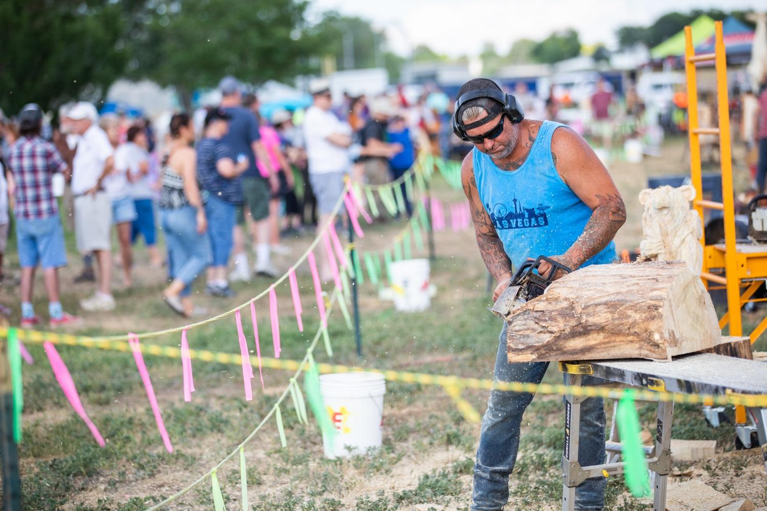 Man carving wood with a chainsaw