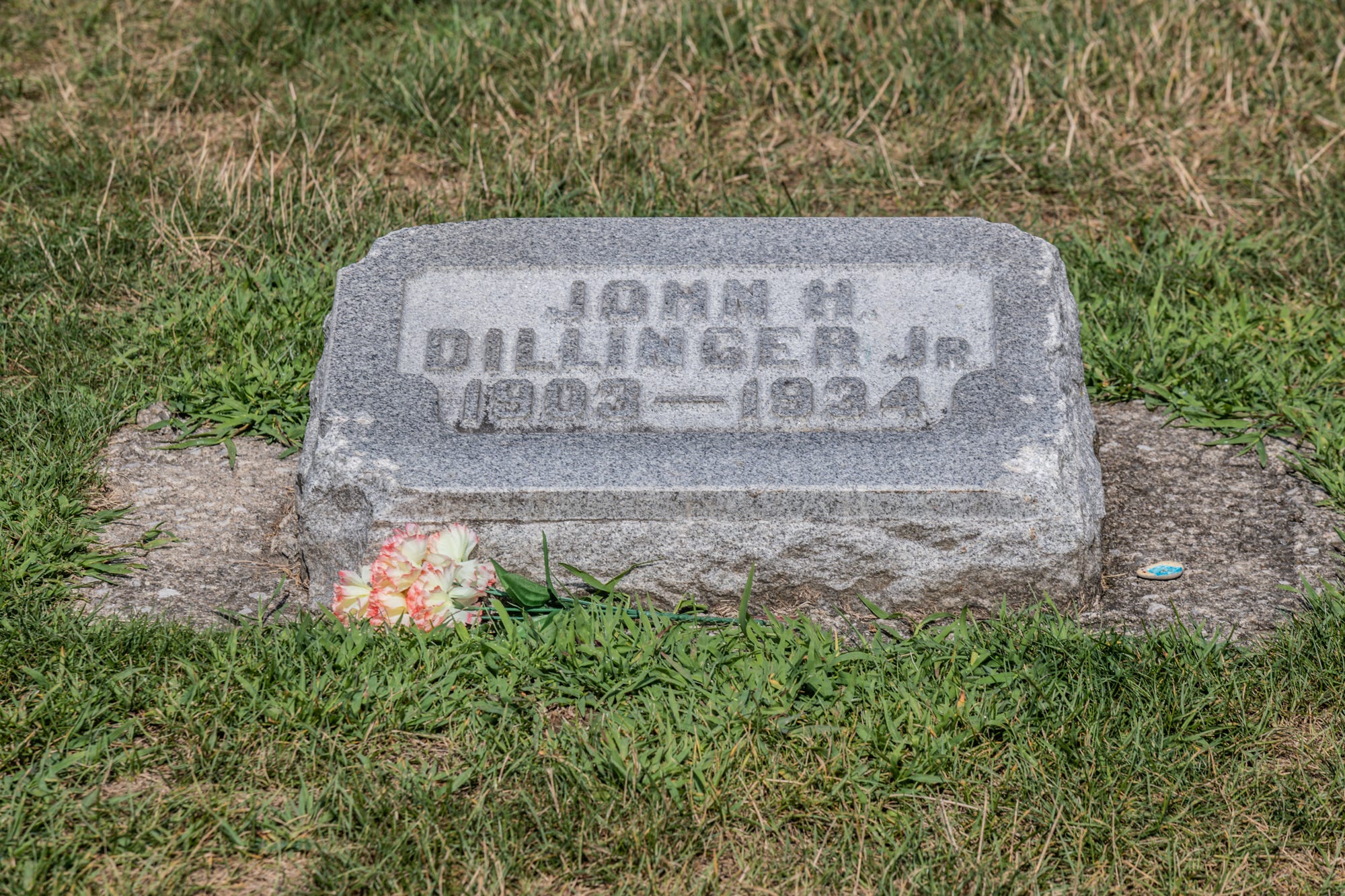 The grave of John Dillinger Jr., 1909-1934, sits inside the walls of Crown Hill Cemetery in Indianapolis on Tuesday, July 30, 2019. Dillinger