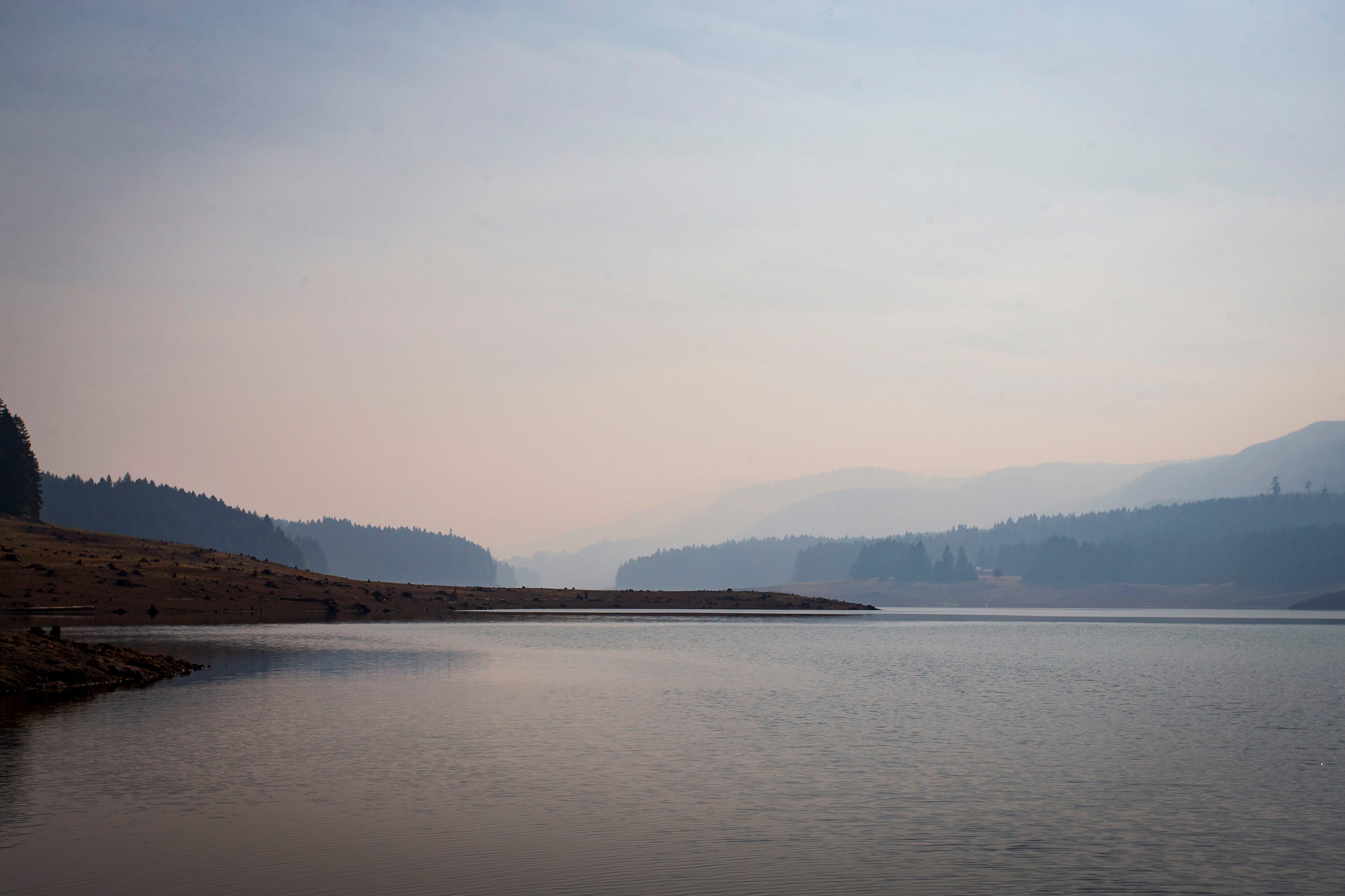Smoke from the Bedrock Fire hangs over Fall Creek Lake on Tuesday.