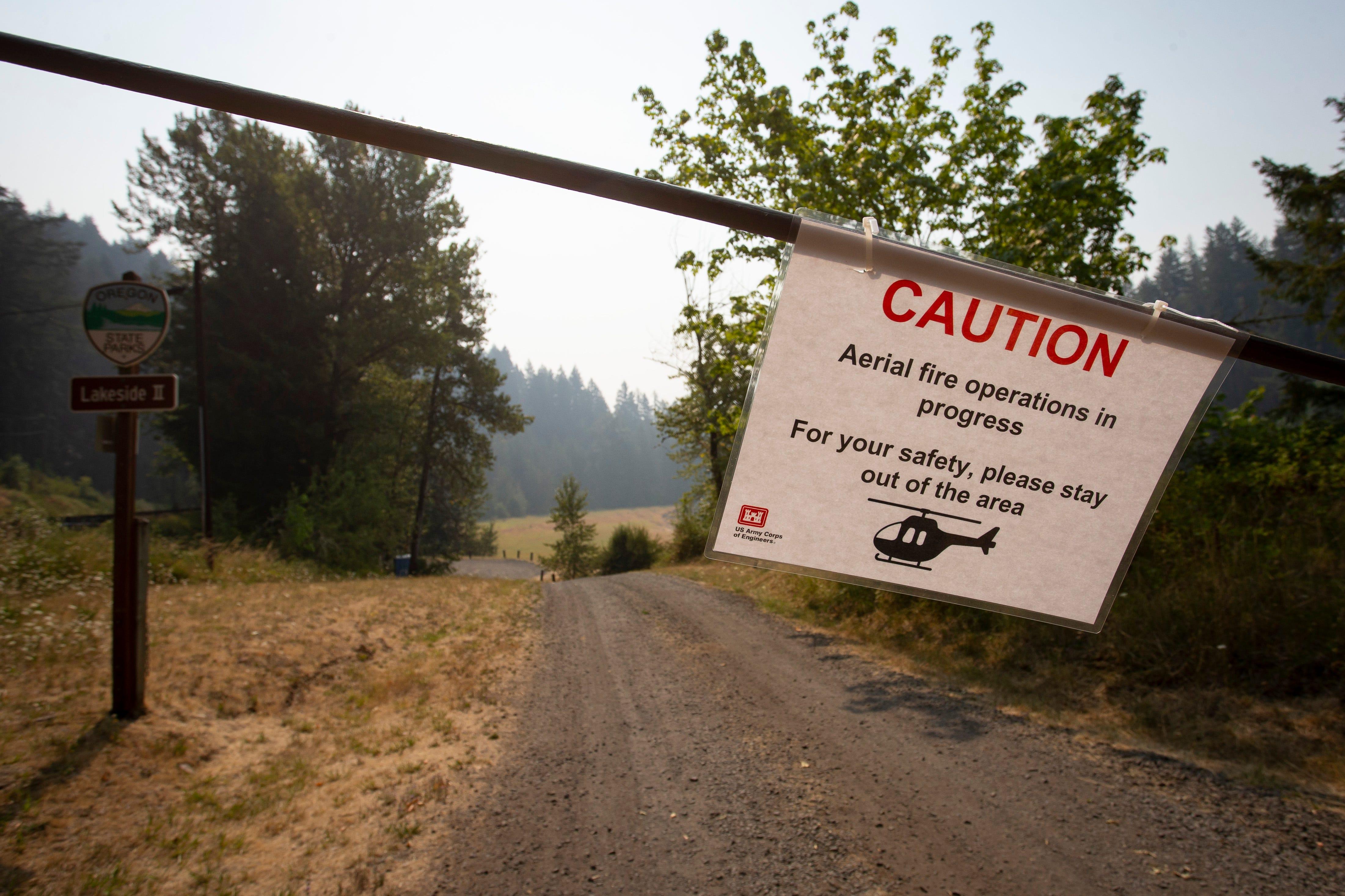 A sign near the east end of Fall Creek Lake warns of closures due to aerial fire operations on Tuesday.
