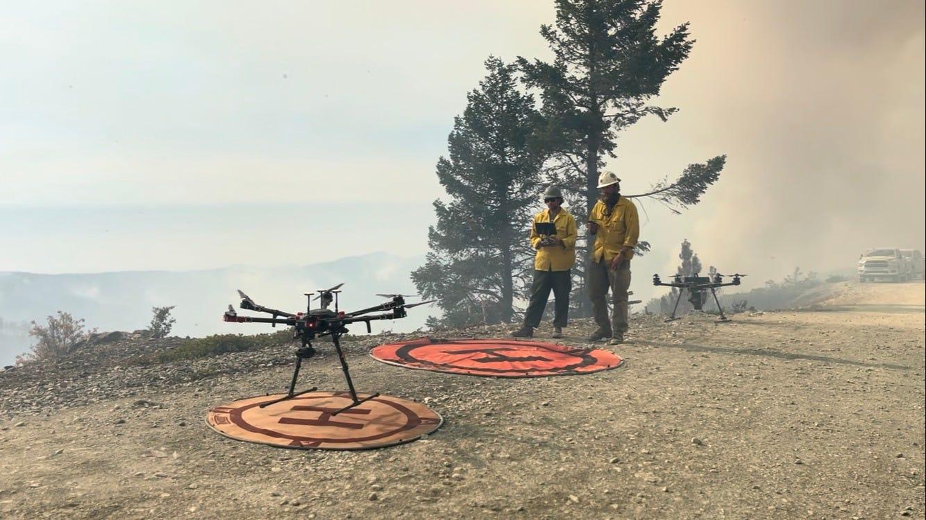 Pilots prepare to launch a UAS to use infrared heat detection around the Flat Fire