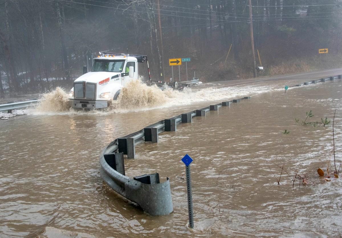 Floodwaters surround a road.