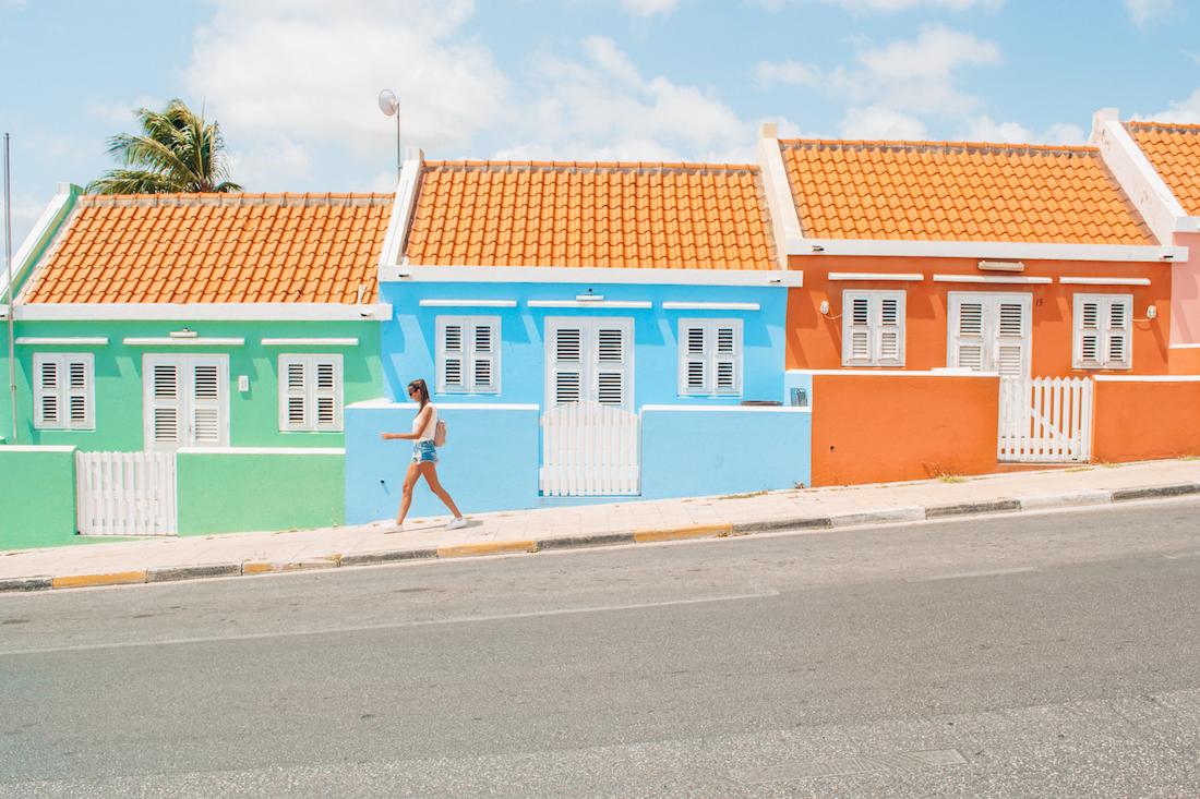 This street on Curacao Island has colorful houses lining both sides of the street.