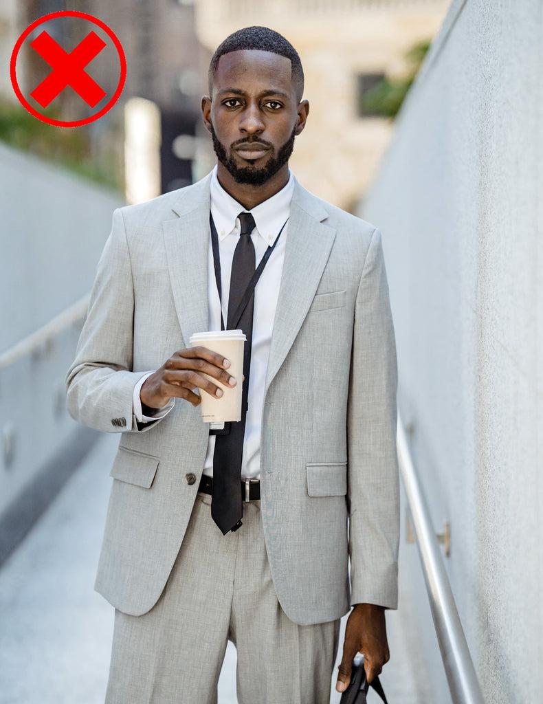 Example of a man wearing a too long tie length