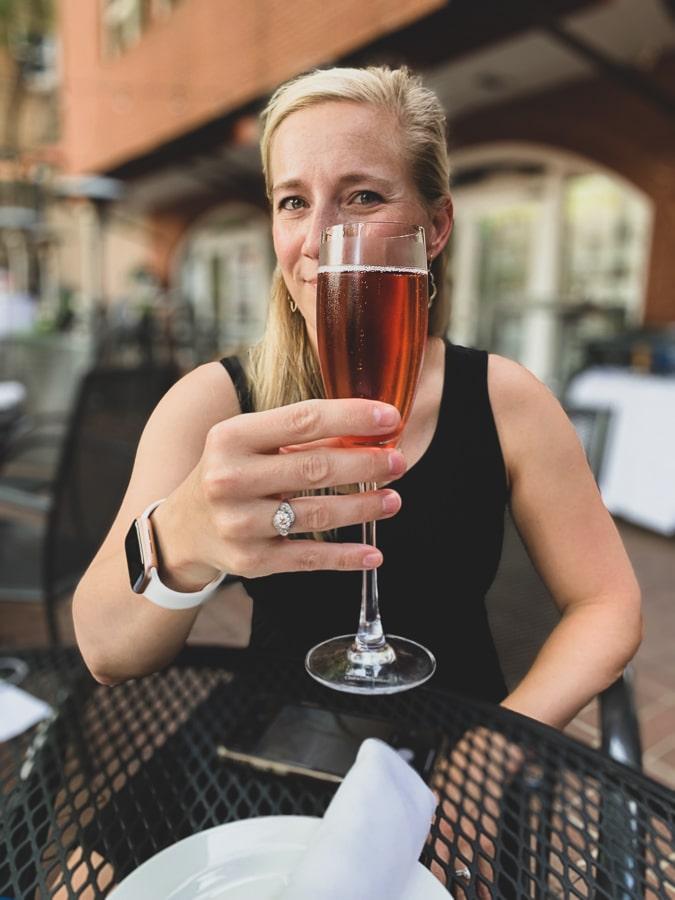 kath drinks champagne in charlottesville patio
