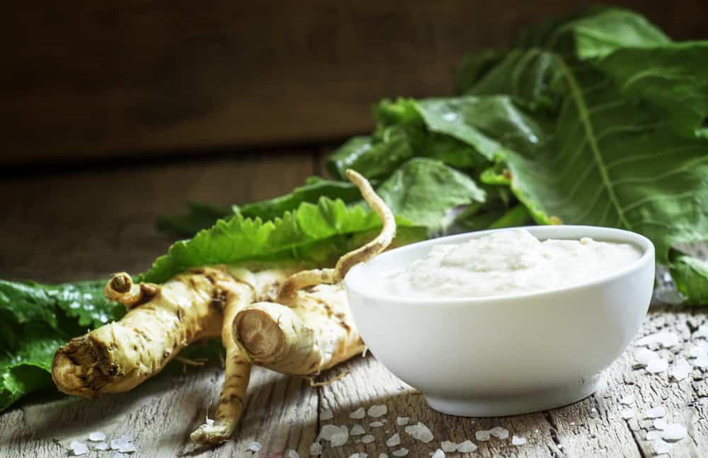 Ground horseradish, hot sauce to the food in a white bowl