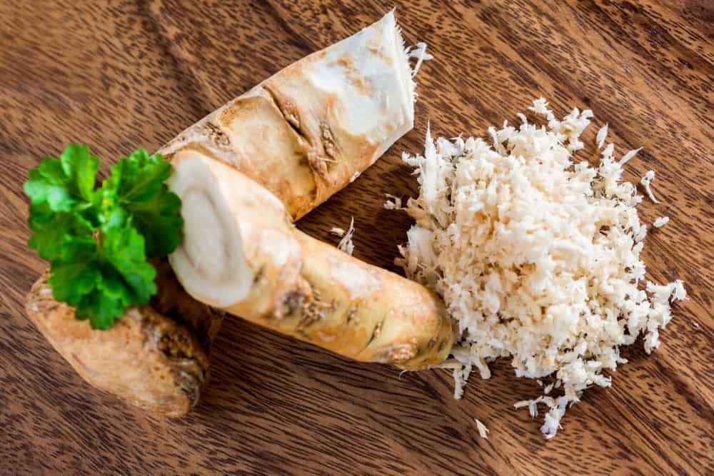 Crushed horseradish prepared on a traditional wooden plate