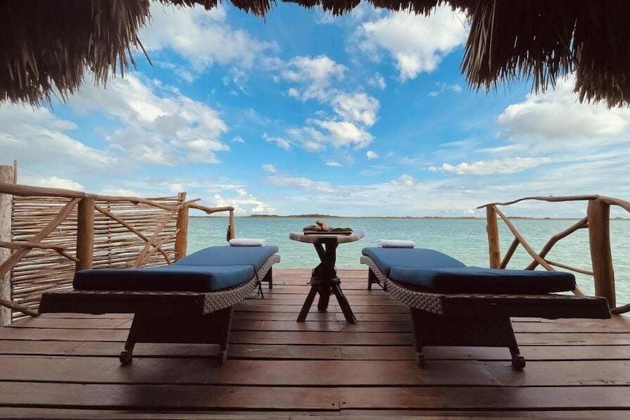 Girl sitting on loungers overlooking the turquoise lagoon