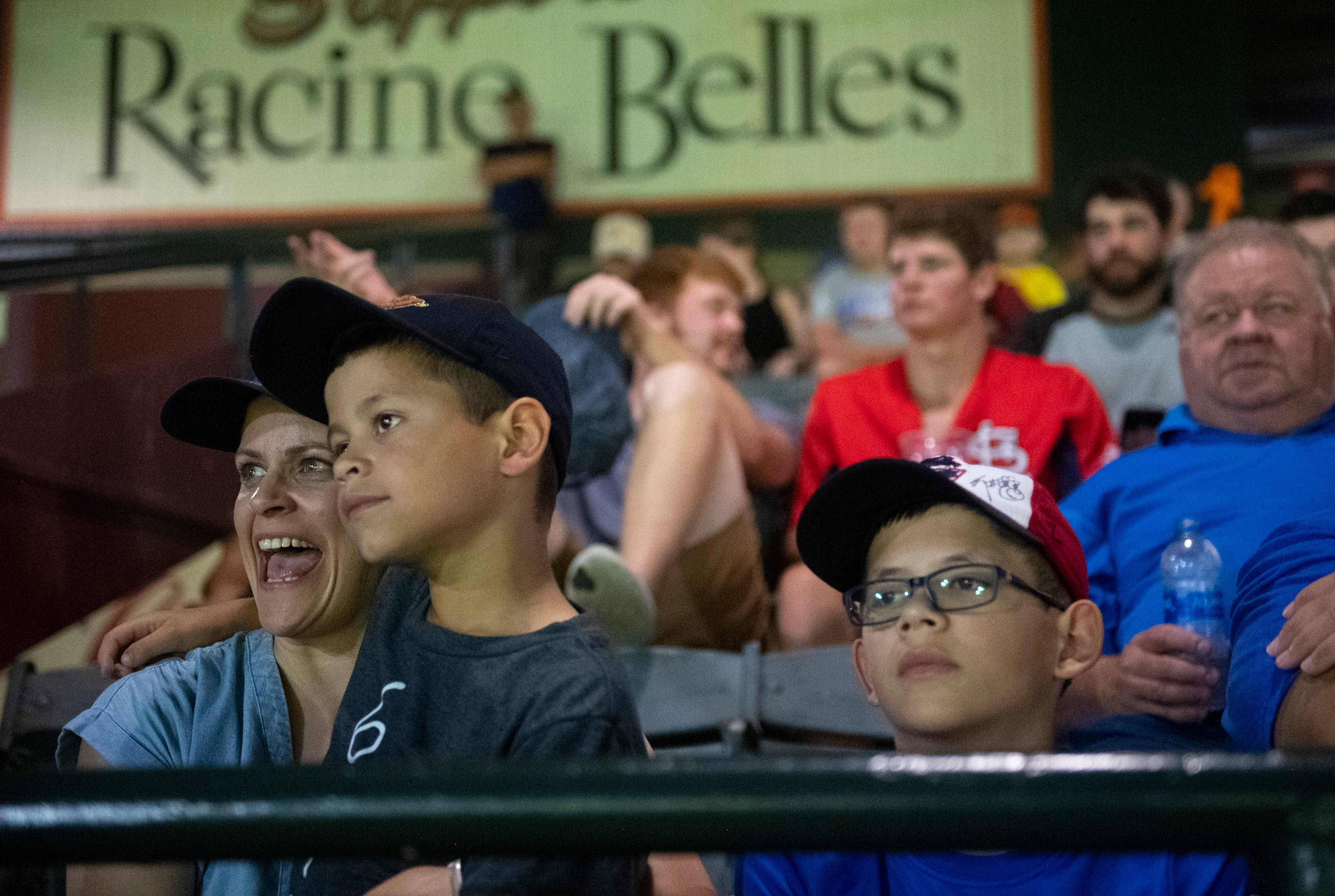 Nicole Lopez, left, Miguel Lopez, 7, middle, and Mateo Lopez, 10, watch the Evansville Otters baseball game at Bosse Field in Evansville, Ind., Friday evening, August 5, 2022. This year is the 30th anniversary of the movie “A League of Their Own” which was partially filmed in Bosse Field.