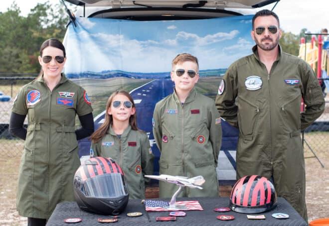 family celebrating trunk or treat dressed as top gun pilots