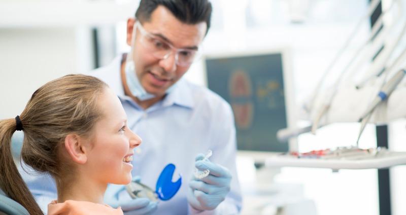 Young female patient being fitted for Invisalign and deciding is invisalign better than braces