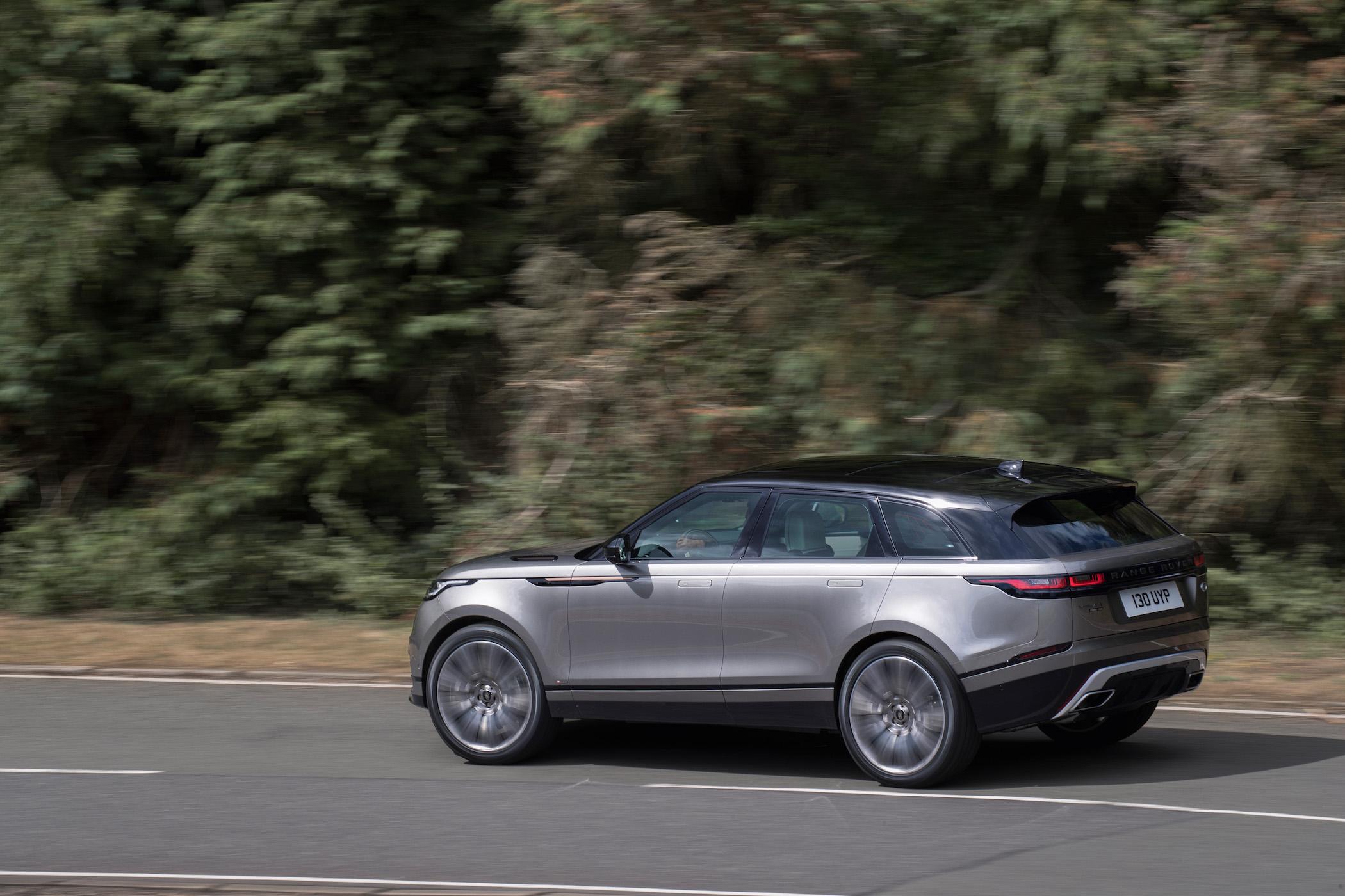 a grey range rover velar driving on a road