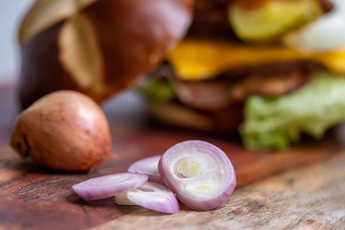 shallots sliced and whole on a cutting board.