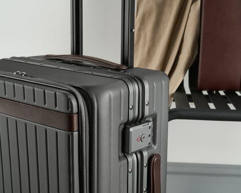 Close up image of a polycarbonate suitcase with leather detailing