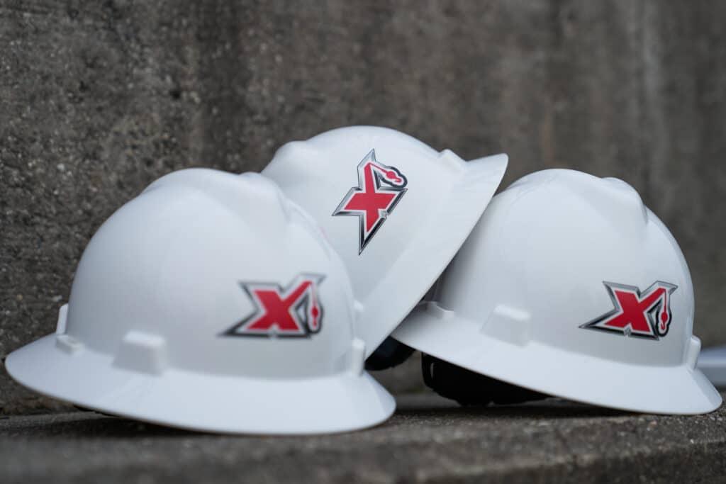 3 Hard hats with the Maxim logo on them