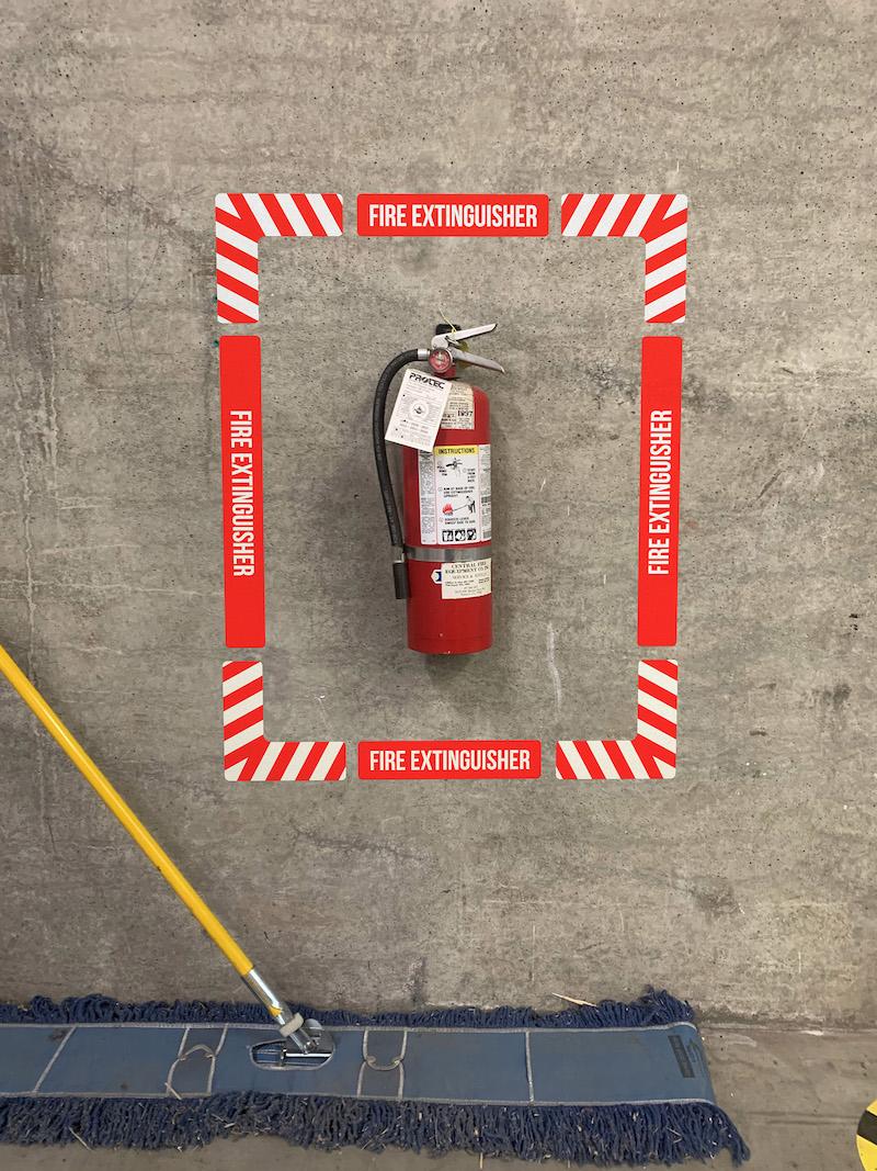 Fire Extinguisher Wall Frame Sign above Broom