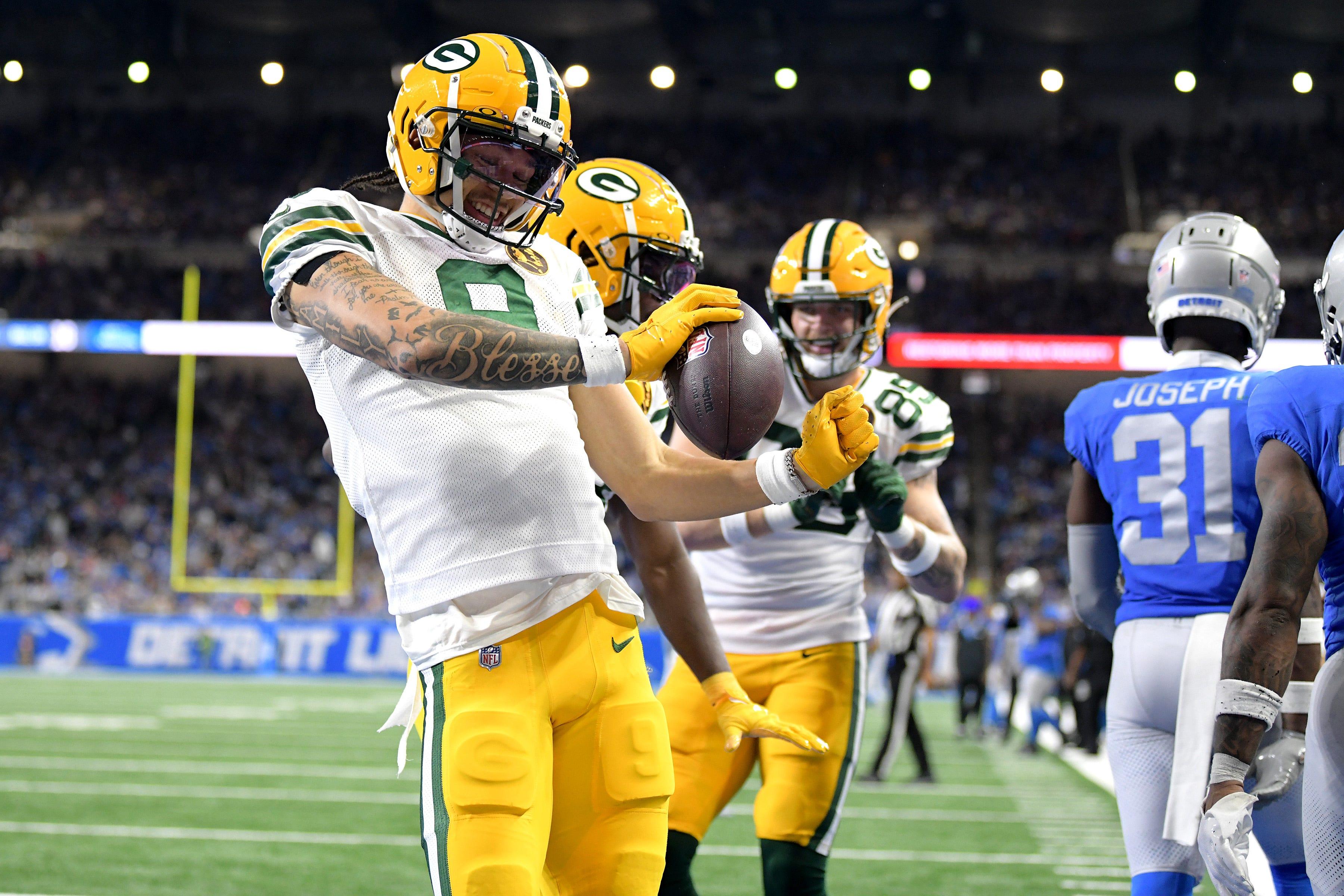 Green Bay Packers wide receiver Christian Watson celebrates after scoring a touchdown against the Detroit Lions.
