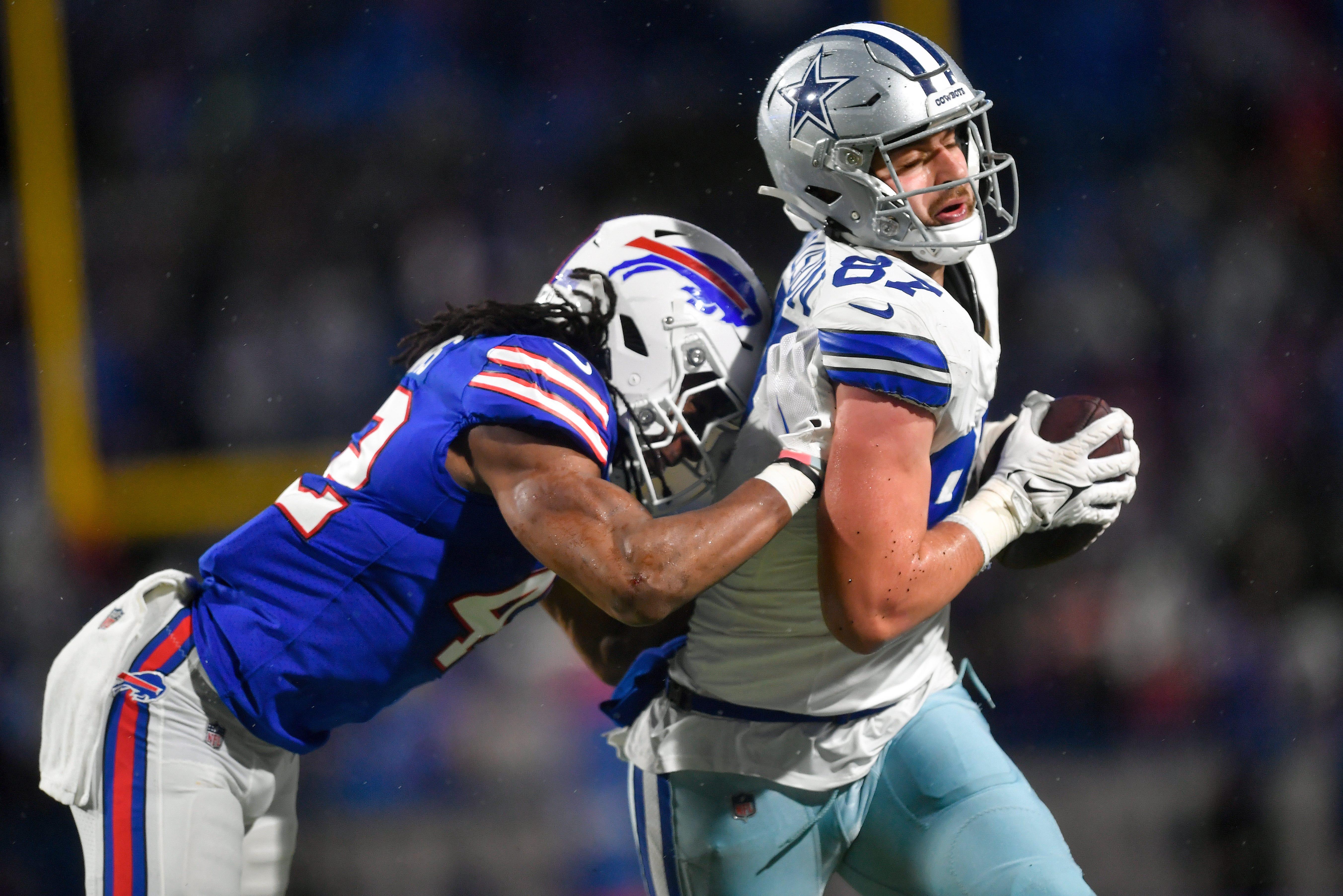 Buffalo Bills linebacker Dorian Williams (42) puts a hit on Dallas Cowboys tight end Jake Ferguson (87) during the fourth quarter of an NFL football game, Sunday, Dec. 17, 2023, in Orchard Park, N.Y. (AP Photo/Adrian Kraus)