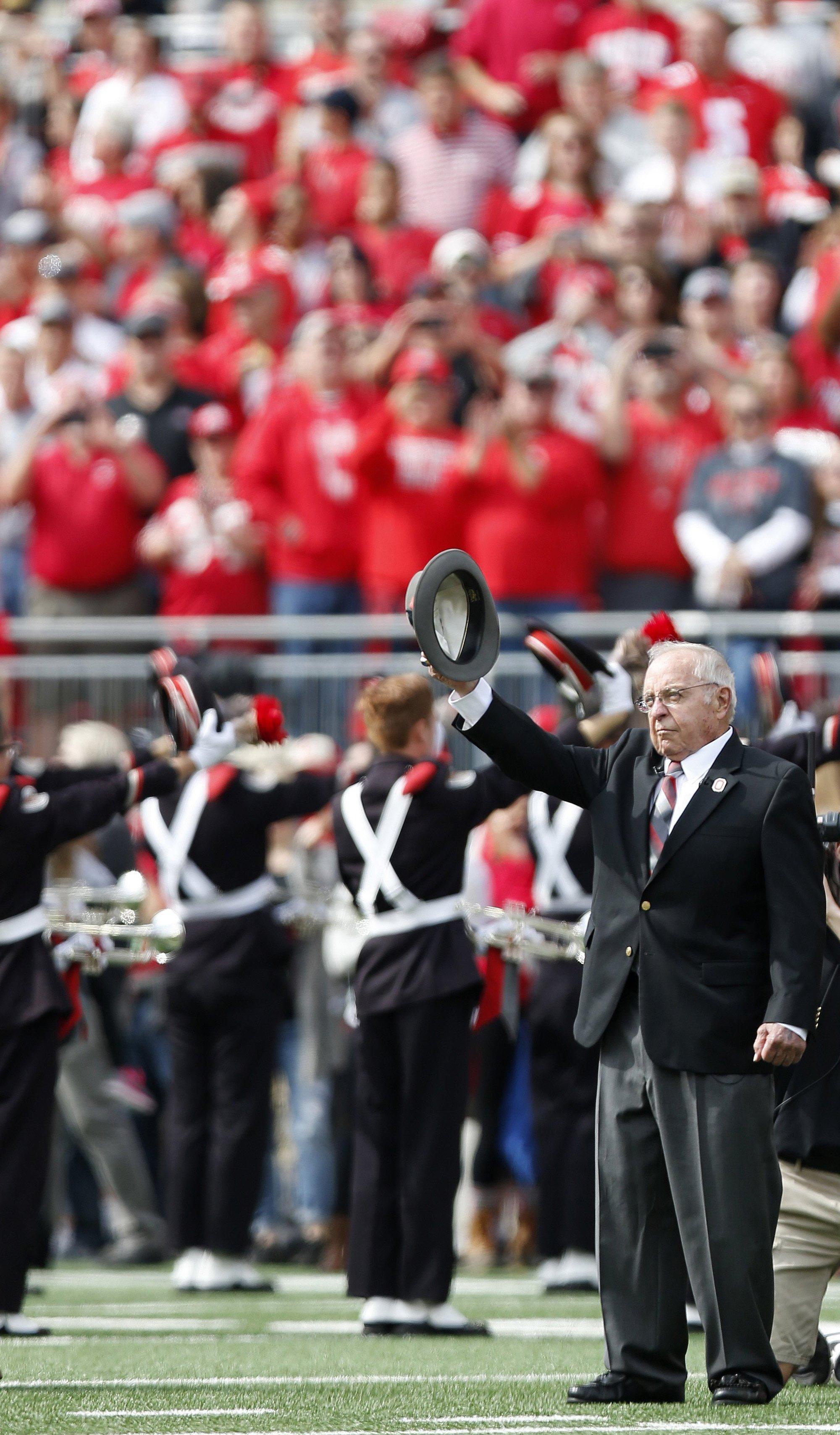 Former head football coach Earle Bruce dots the "i" in Script Ohio before the NCAA football game between the Ohio State Buckeyes and the Rutgers Scarlet Knights at Ohio Stadium on Saturday, October 1, 2016.