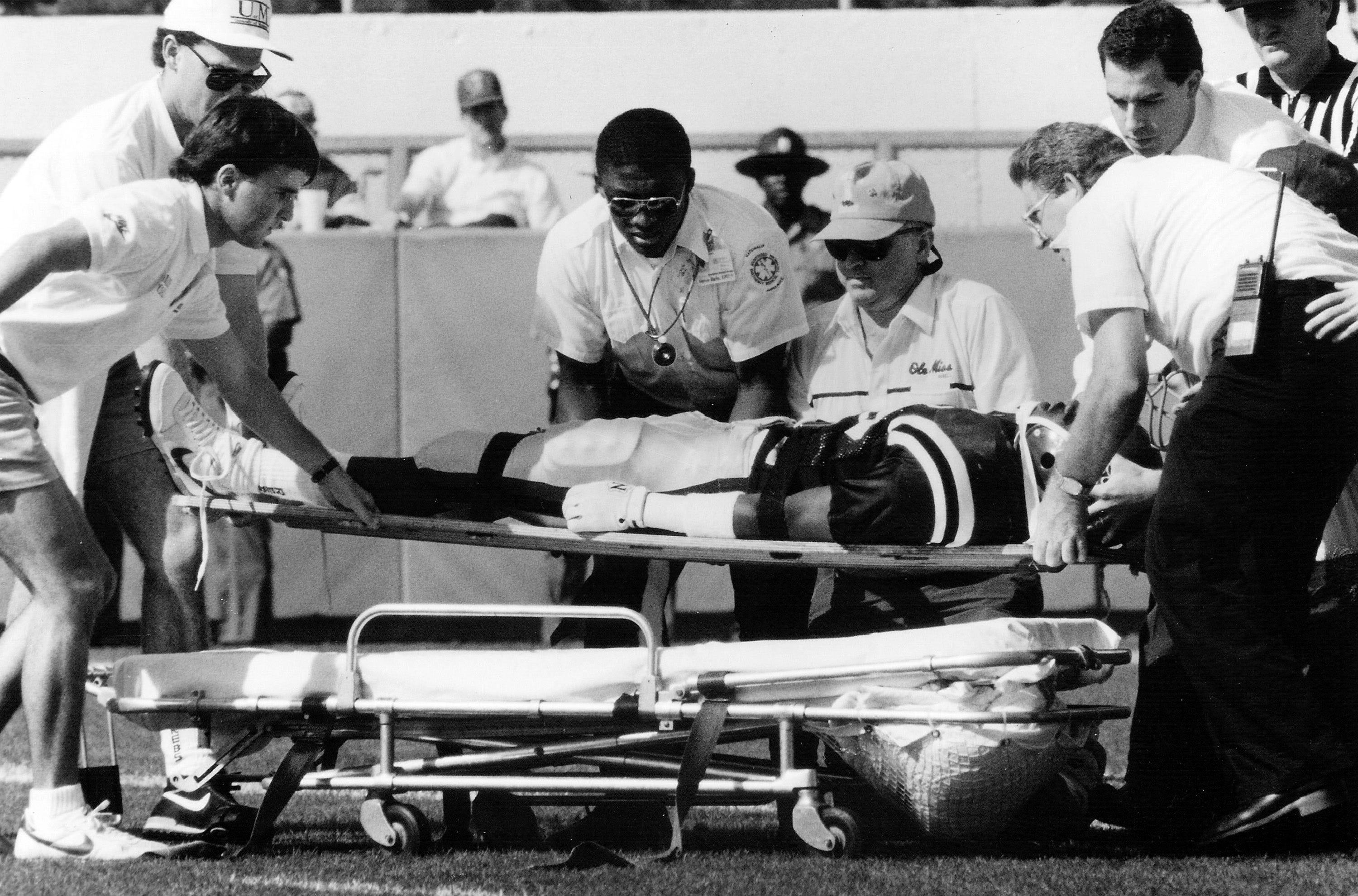 In this Oct. 28, 1989, file photo, Mississippi defensive back Roy Lee "Chucky" Mullins is placed on a stretcher after suffering a paralyzing neck injury as he made a head-first tackle against Vanderbilt fullback Brad Gaines following a short pass in an NCAA college football game in Oxford, Miss. The tackle paralyzed Mullins from the neck down. He died on May 6, 1991 of complications resulting from the injury, and since then his No. 38 jersey has been given to a Mississippi defender to wear as the Chucky Mullins Courage Award.