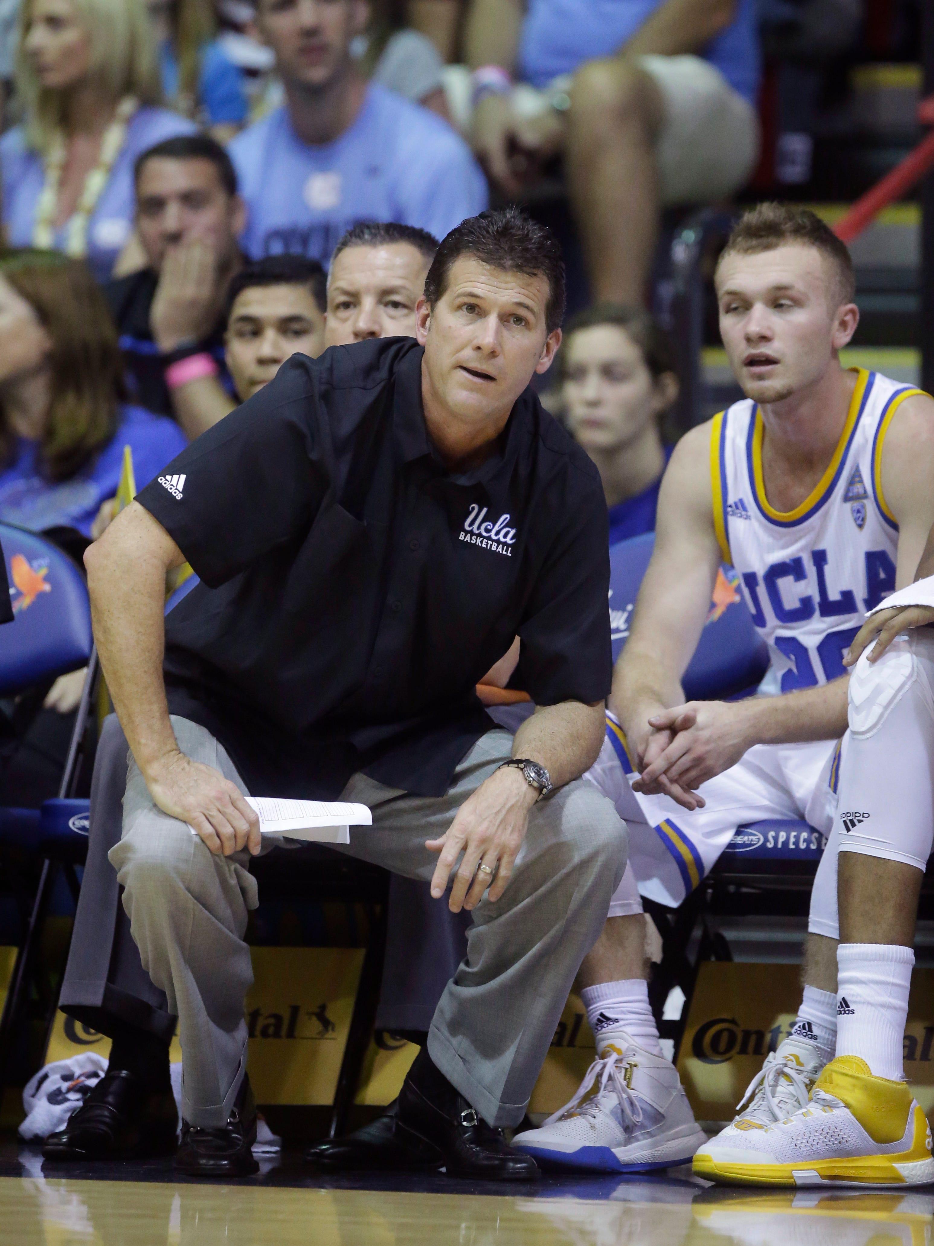 UCLA head coach Steve Alford and UCLA guard Bryce Alford, right, look on in the first half during an NCAA college basketball game against Kansas in the second round of the Maui Invitational, Tuesday, Nov. 24, 2015, in Lahaina, Hawaii. (AP Photo/Rick Bowmer)