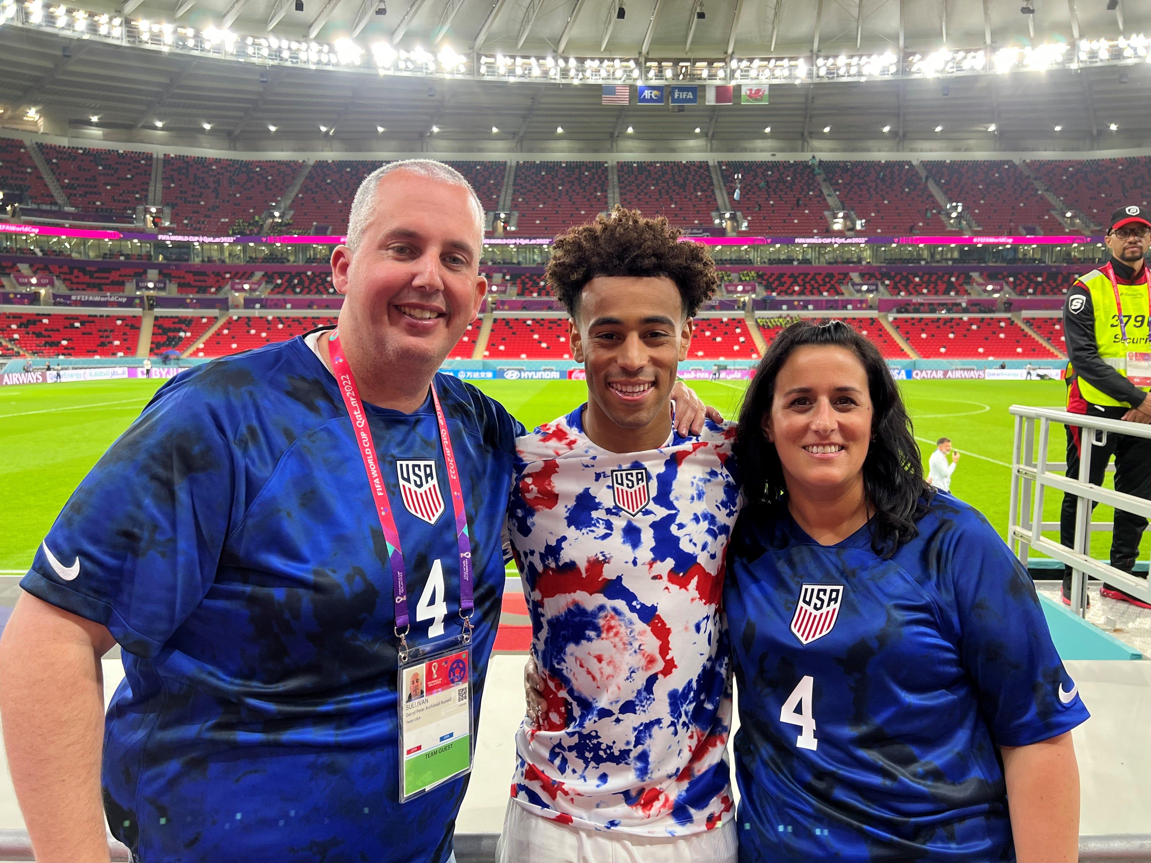 Tyler Adams, center, poses his parents, Darryl Sullivan Sr. and Melissa Russo, after the United States men