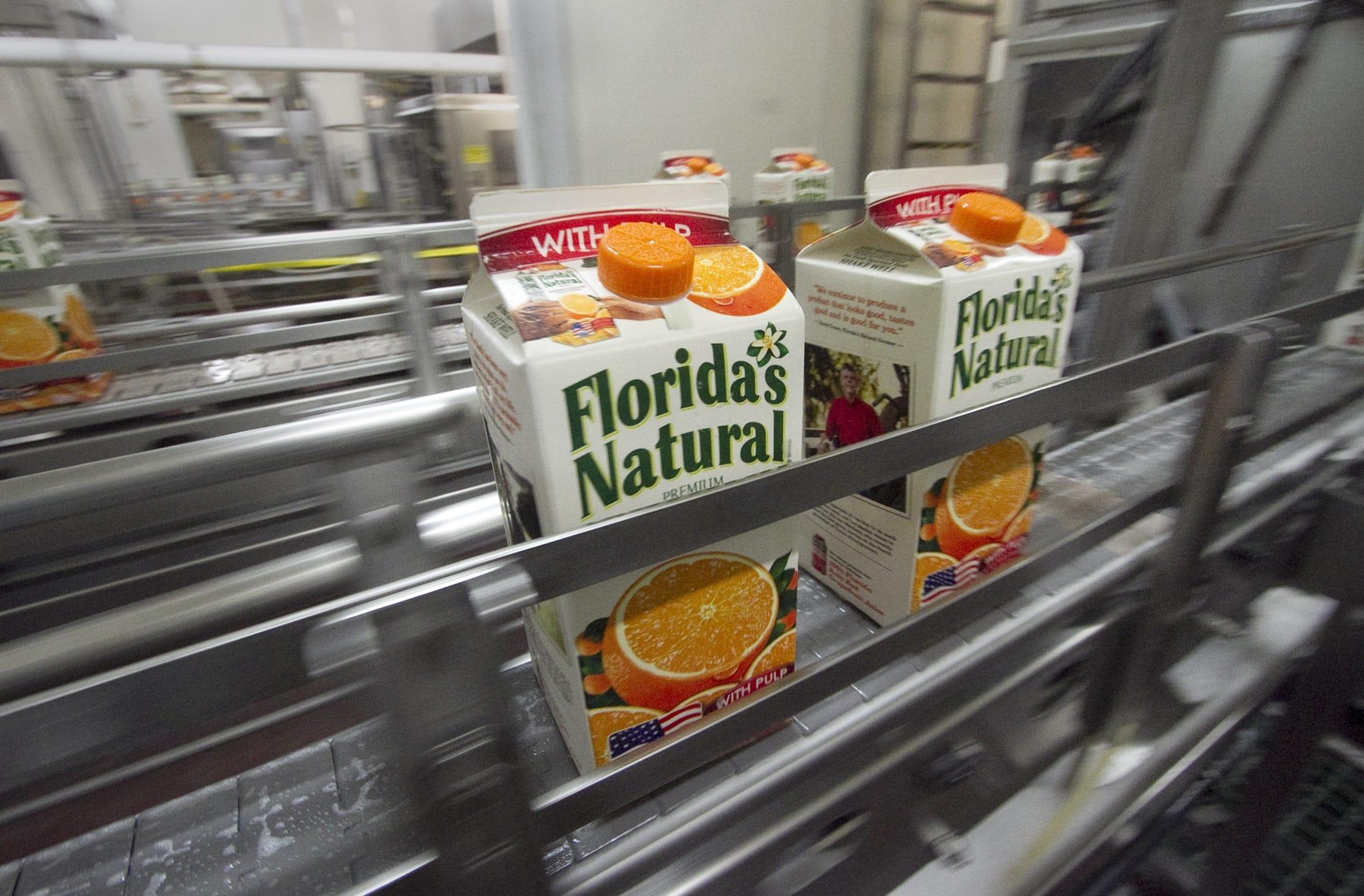 Cartons of fresh Florida orange juice roll off the line at Florida