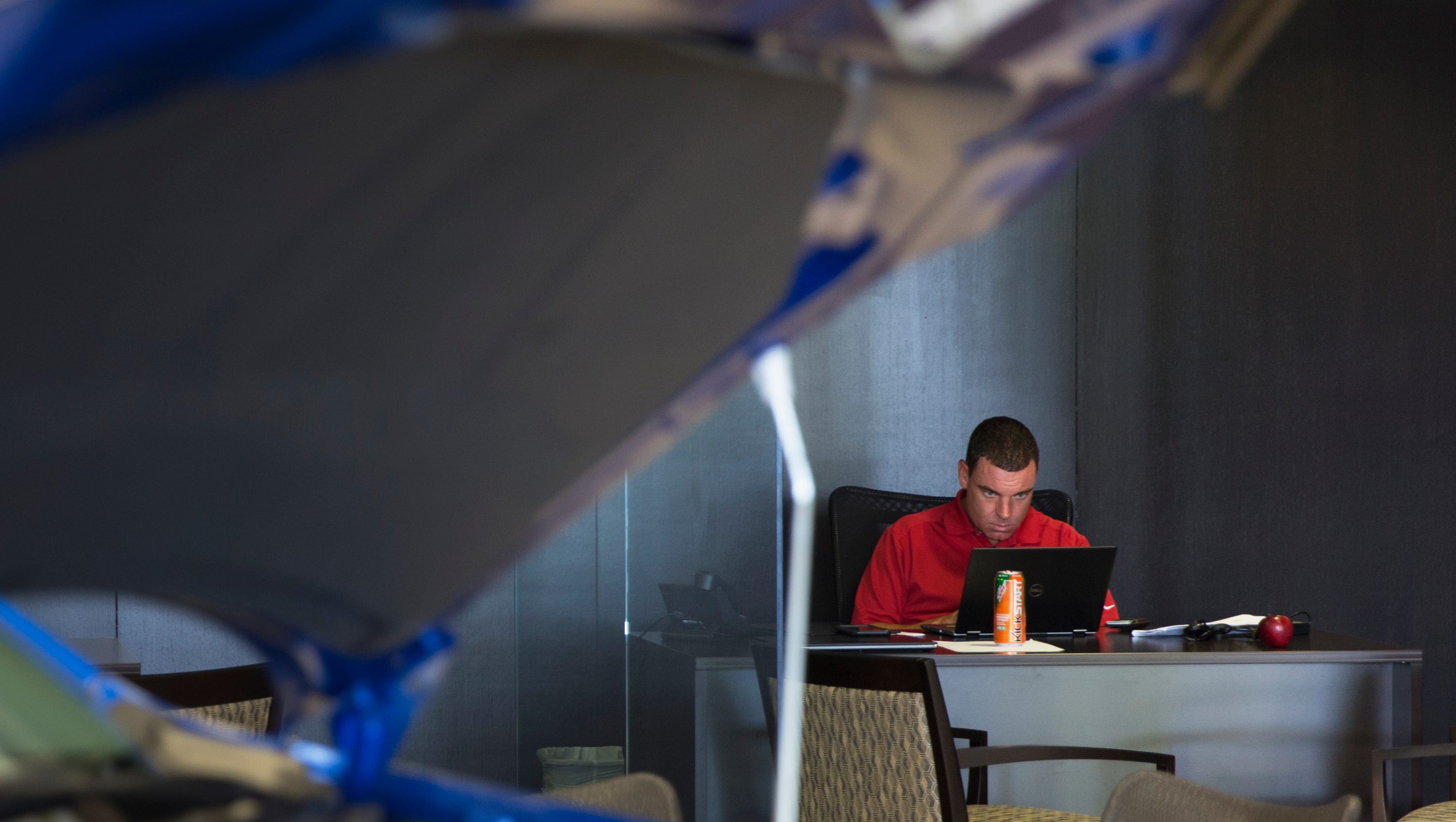 Jason Autry, of Fort Myers, works from his desk in the new Mitsubishi showroom on July 14, 2016, in Bonita Springs. Opening last weekend, the Naples-Bonita Springs area provides a great and competitive market for the new and expanding dealership.